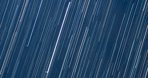 Abstract image white light streaks on blue background