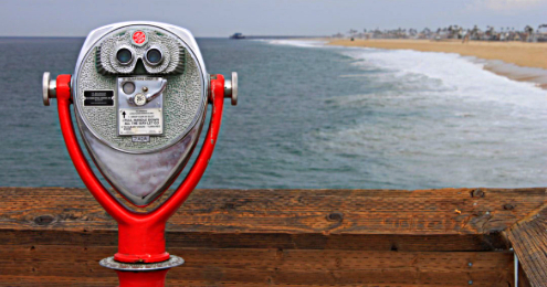 Outdoor binocular viewer in red over landscape